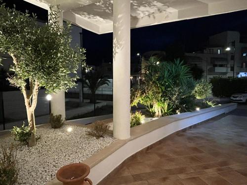 a courtyard in a building at night with lights at Bikini Hotel in Vieste