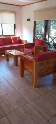 a living room with couches and a coffee table at Cabañas Rancho Pinares in Pichilemu