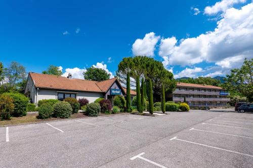 a parking lot in front of a hotel at Kyriad Digne-Les-Bains in Digne-les-Bains