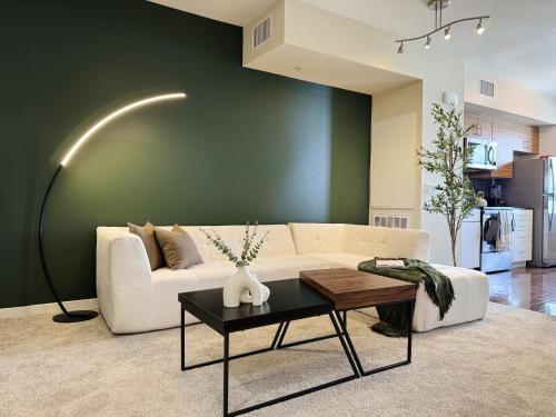 a living room with a white couch and a table at Stylish 1 Bedroom Apartment in LA with Free Parking - 10 Minutes away from Ceders Sinai in Los Angeles