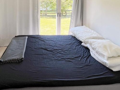 a bed sitting in a room with a window at 6 person holiday home in LAHOLM-By Traum in Laholm