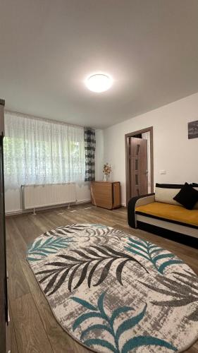 a bedroom with two beds and a rug on the floor at Alice Apartment in Roman