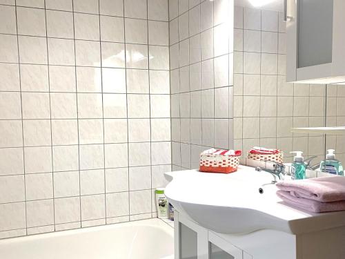 a white bathroom with a sink and a tub at Forest Stay in Elbingerode in Elbingerode