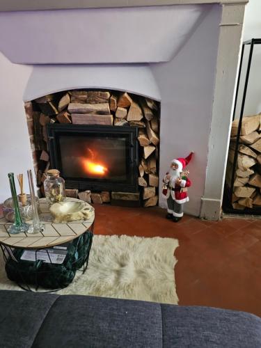 a living room with a fireplace with a christmas ornament at Villa Rustic in Coulours