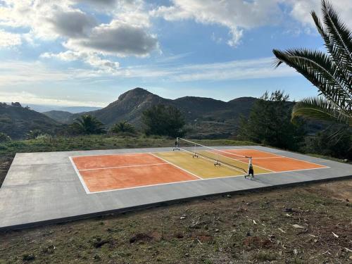 a tennis court in the middle of a mountain at Gorgeous Private Estate with Pool & Pickleball Court in Lakeside