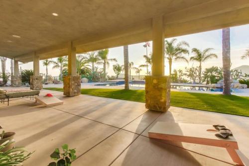 a large patio with a view of the palm trees at Gorgeous Private Estate with Pool & Pickleball Court in Lakeside