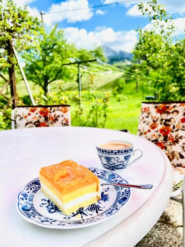 a piece of cake and a cup of coffee on a table at Ferienhaus Faaker See 23 in Faak am See