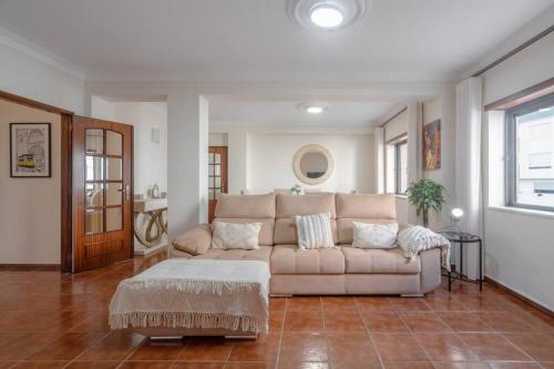 a living room with a couch and a table at Terrace Beach Apartment in Buarcos