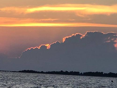 a cloud formation in the sky over the water at Tiny House at Piney point in Piney Point