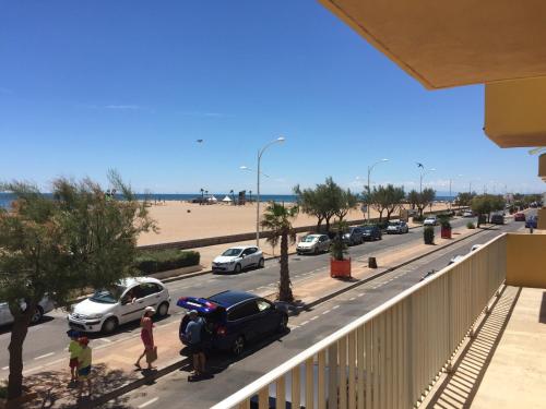 - un balcon donnant sur une rue avec des voitures dans l'établissement Front de mer 100m2 Vue magnifique, balcon, jardin, garage, à Valras-Plage