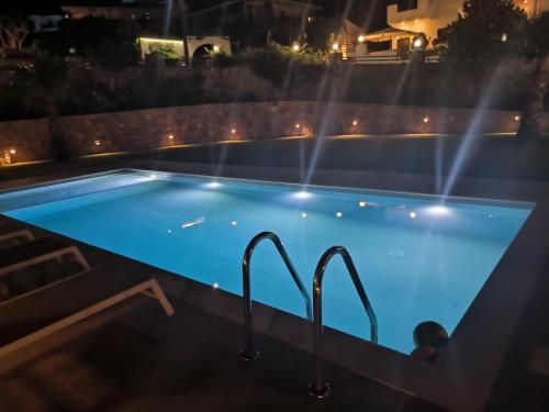 a swimming pool at night with lights at Cost Mari Almyrida New by ZAGO Boutiqe hotels in Almirida