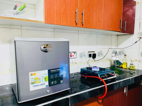 a kitchen with a counter top with a stove at Convenient city apartment with free WiFi in Dar es Salaam