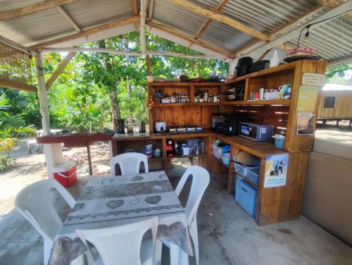 a kitchen with a table and a table and chairs at Camping Babsita in Tuba Creek