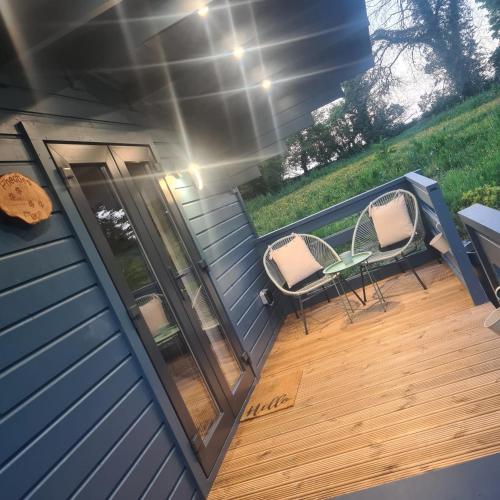 a deck with two chairs and a table on a house at Pheobes Place in Athlone