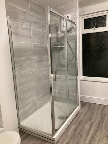 a shower with a glass door in a bathroom at Beautiful holiday home near Plymouth for 4 in Plymouth
