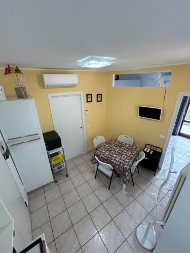a kitchen with a table and chairs in a room at Casa al mare in Fano