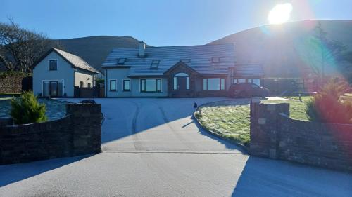 a house with the sun shining on a driveway at Lighthouse View in Tralee