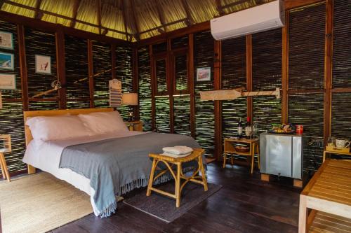 a bedroom with a bed in a room with wooden walls at Solea Villa Tropical in Santa Marta
