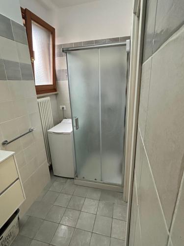 a shower stall in a bathroom with a toilet at Casa al mare in Fano