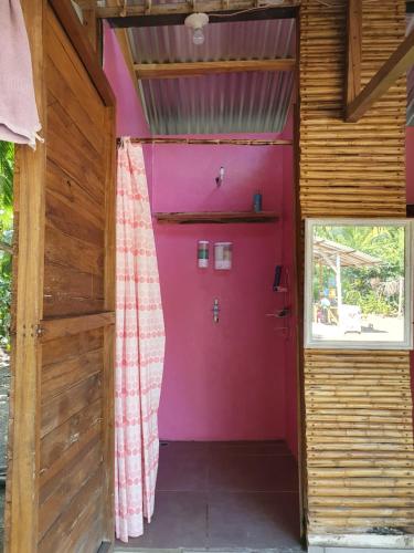 a room with a pink door in a house at Camping Babsita-TIPI und Hütten und Stellplätze für Zelt und Camper direkt am Meer und See in Tuba Creek