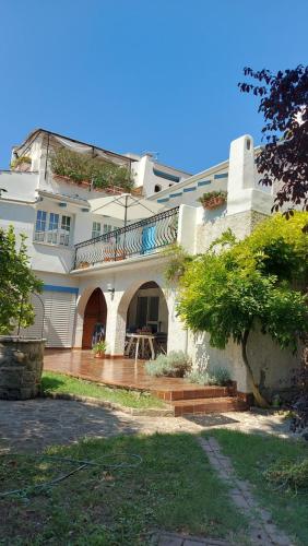 a large white house with a large patio at Apartments Stella - parking in Piran