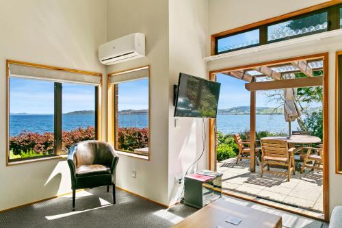 a living room with a view of the ocean at Cascades Lakefront Motel in Taupo