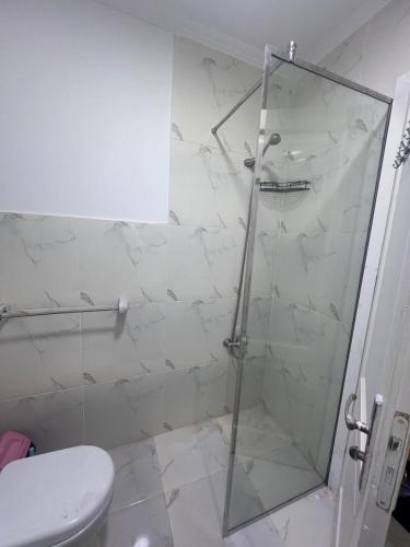 a bathroom with a glass shower with a toilet at Property Sisters Madinaty, Elite garden view B2 in Madinaty