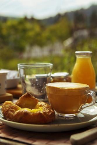 a table with a cup of coffee and a plate of food at Agriturismo Montefabbrello in Magazzini