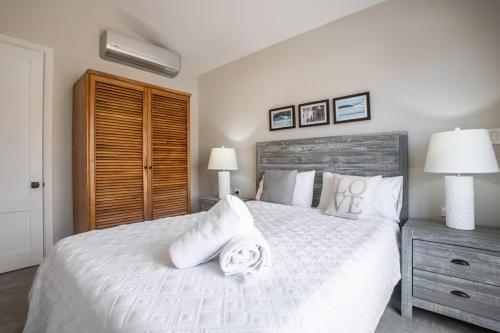 a bedroom with a white bed with two pillows on it at Villa #31 - Blue Venao, Playa Venao in Playa Venao