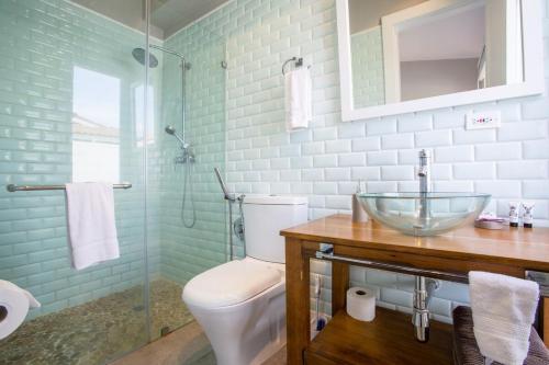 a bathroom with a toilet and a glass sink at Villa #31 - Blue Venao, Playa Venao in Playa Venao