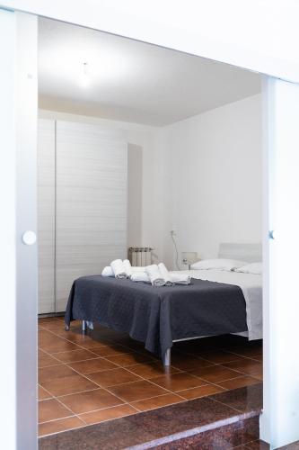 a white bedroom with a bed and white walls at Mera House in Posada