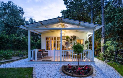 a tiny house with a porch in a garden at Chalet i Poggetti in Torretta