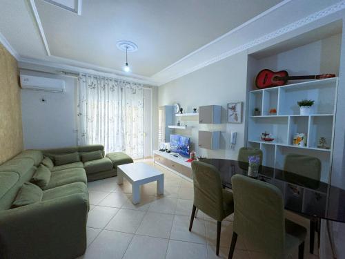 a living room with a couch and a table at H-Apartment Lungo Mare in Vlorë