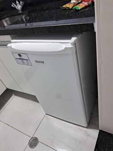 a white dishwasher in a kitchen next to a sink at hotel tambau flat particular 605 in João Pessoa