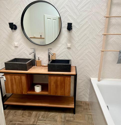 a bathroom with two sinks and a mirror at COAST HOUSE Sky Suite in Bremerhaven