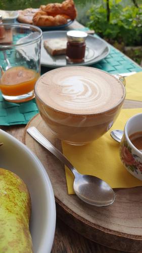 a wooden table with a cup of coffee and a spoon at Agriturismo Montefabbrello in Magazzini