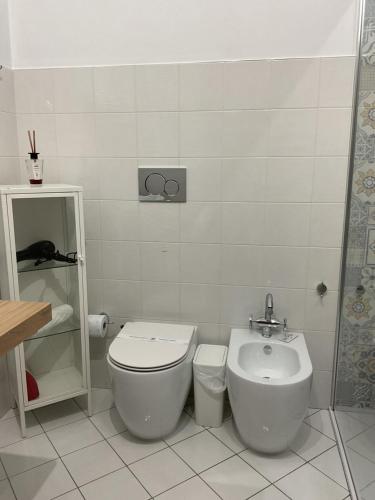 a bathroom with a toilet and a sink at Rossaroll Holiday Houses in Noto