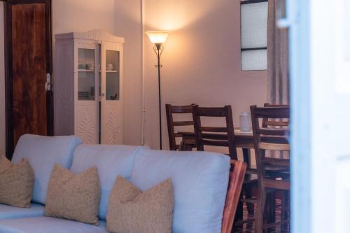 a living room with a couch and a table and chairs at Casa Ramona in Flores