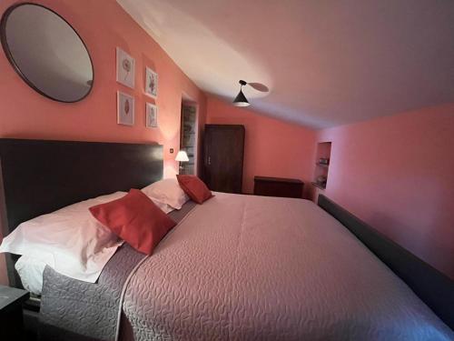 a bedroom with a large bed with a large mirror at A casa di Giovanni apartment in Albano di Lucania