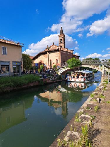 un fiume con barche di fronte a una chiesa di Adele in Darsena a Milano