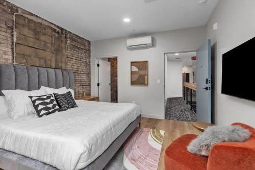 a bedroom with a large bed and a tv at BlueJay Hotel in Grand Rapids