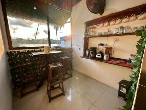 a kitchen with a counter and stools in a room at Beautiful View House in Tortuguero