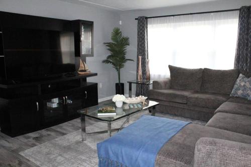 a living room with a couch and a tv at Rotonda Pool Oasis Near Beaches - Sleeps 9 in Rotonda West