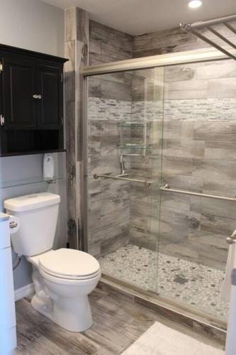 a bathroom with a toilet and a glass shower at Rotonda Pool Oasis Near Beaches - Sleeps 9 in Rotonda West
