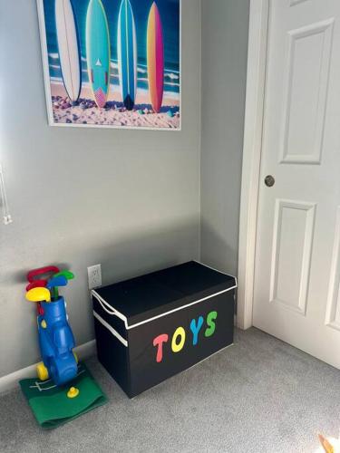 a black box with toys next to a wall with surfboards at Rotonda Pool Oasis Near Beaches - Sleeps 9 in Rotonda West