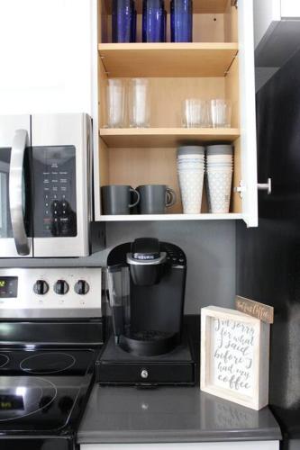 a kitchen counter with a coffee maker and a microwave at Rotonda Pool Oasis Near Beaches - Sleeps 9 in Rotonda West