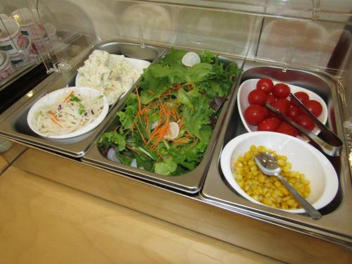 a tray filled with different types of food on a table at ビジネスホテル 山手INN in Iidamachi