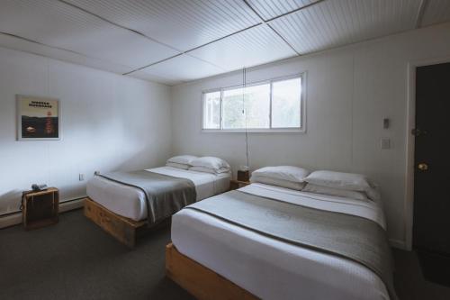 a bedroom with two beds and a window at The Graham & Co. in Phoenicia