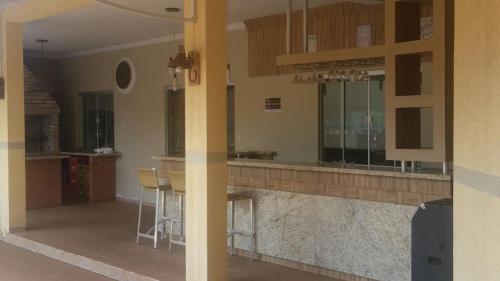 a kitchen with a bar with stools in it at Tacuru Hotel Boutique in Salto del Guairá
