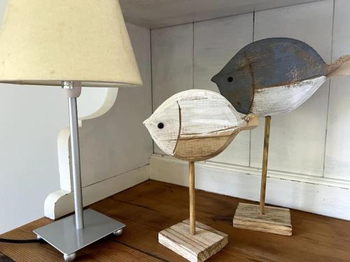 two hats on display next to a lamp at iL VICOLO NEL VERDE in Rio Marina